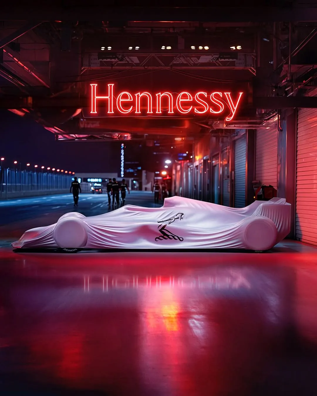 White-covered Formula 1 race car parked beneath a glowing red Hennessy neon sign at night — virtual production studio Thinkdiff, photography & art direction by Thinkdiff AI Production House