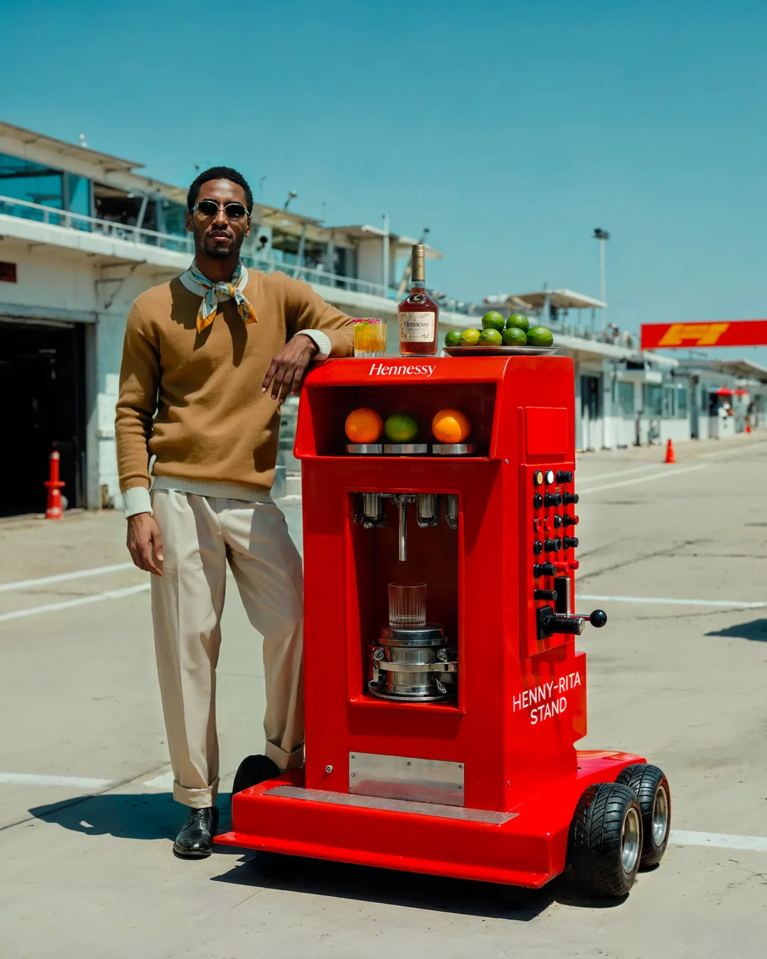 Man walking a red wheeled Hennessy drink cart along an airport tarmac — ai advertising agency Thinkdiff, photography & art direction by Thinkdiff AI Production House