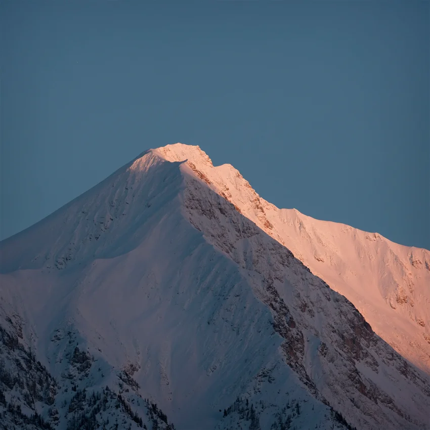 Snow-capped mountain peak glowing pink at sunset against a clear dusk-blue sky for Dom Pérignon — 3d product animation Thinkdiff, photography & art direction by Pierrick Jégou, produced by Thinkdiff AI Production House
